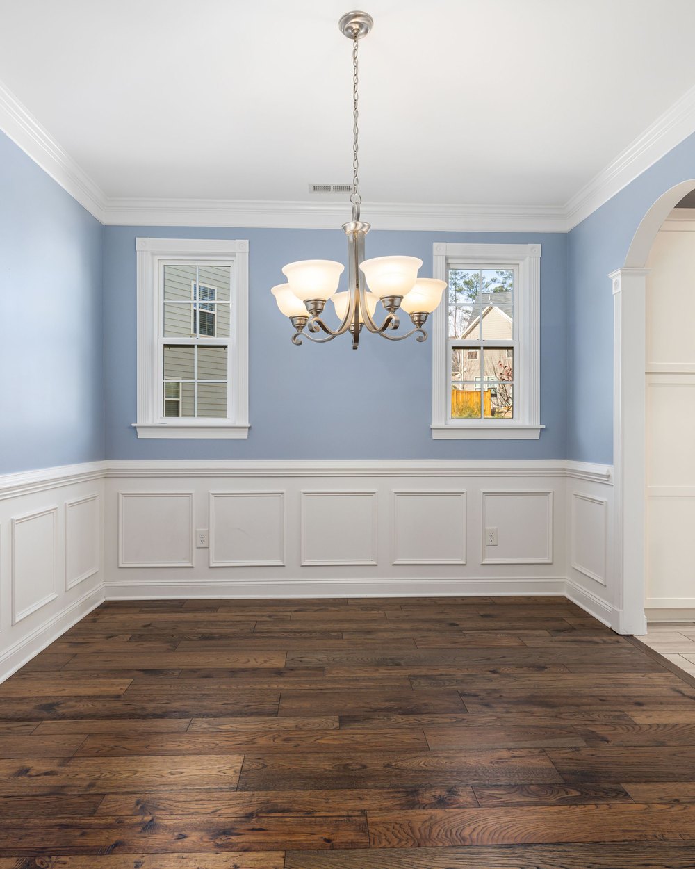 Finished room with crown molding and wainscoting trim, illustrative stock photo